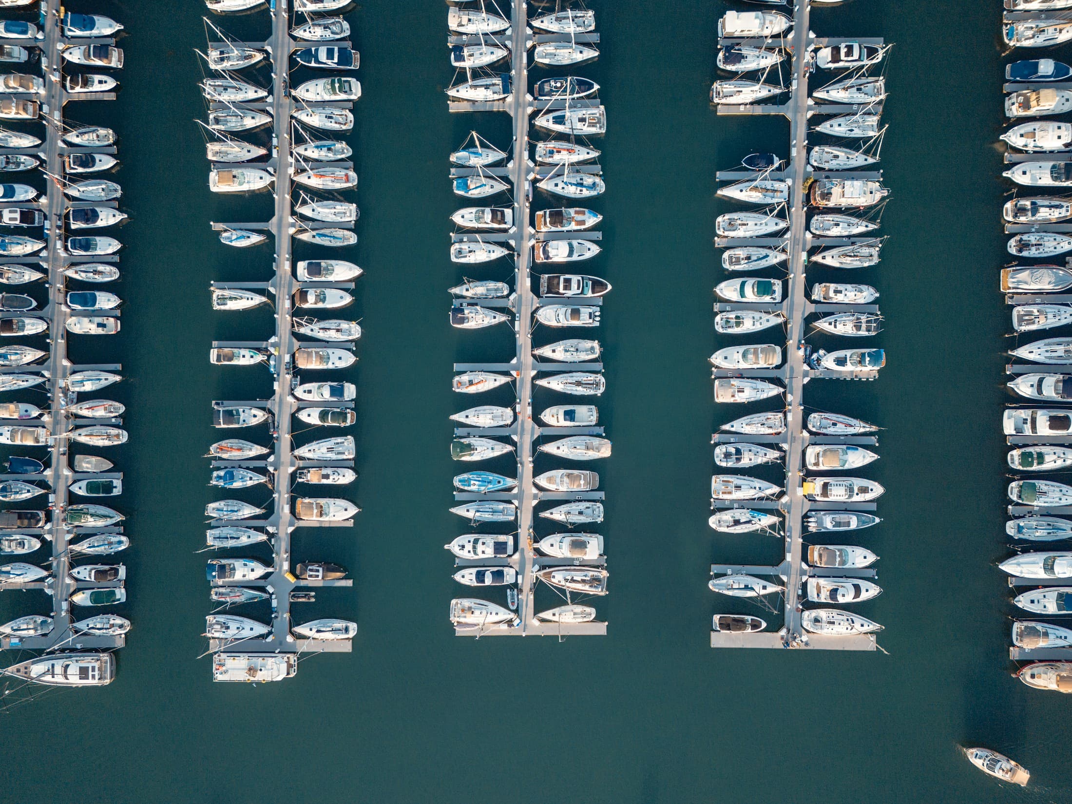 Aerial view of organized marina slips and docked boats