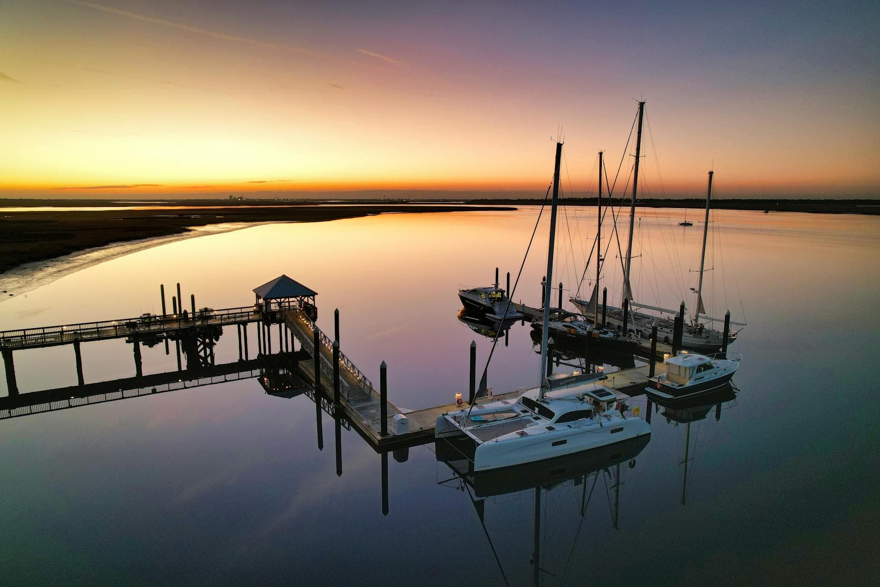 Yachts at their marina berths in the warm light of sunset