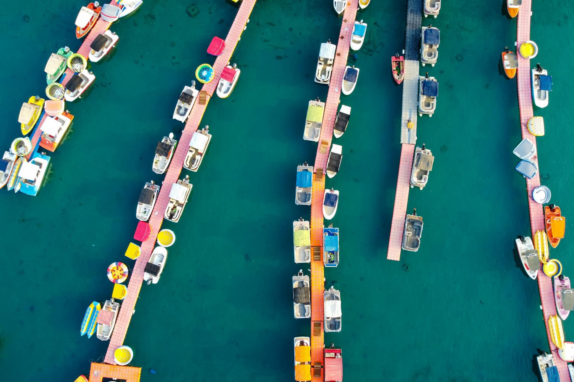 Marina docks and boats arranged across clear turquoise water